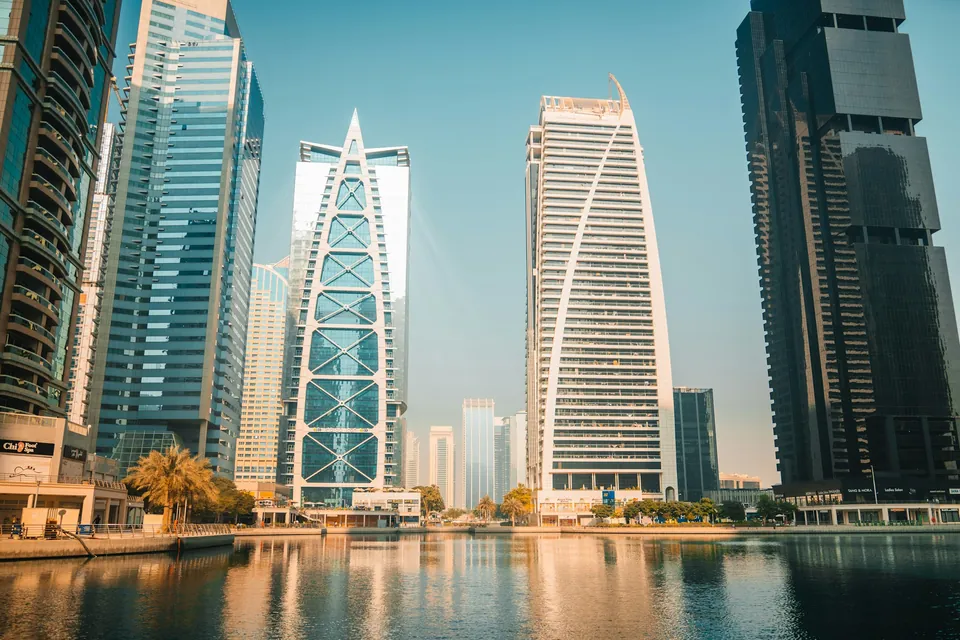 Sunlit towers beside the waterfront in Dubai, United Arab Emirates